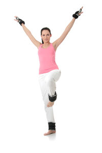 Full length of woman standing against white background