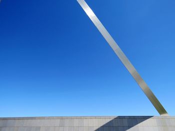 Low angle view of vapor trail against clear blue sky