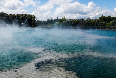 Scenic view of steam over sulphuric hot springs against sky