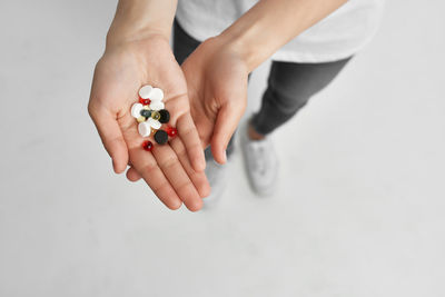 High angle view of woman holding hands over white background