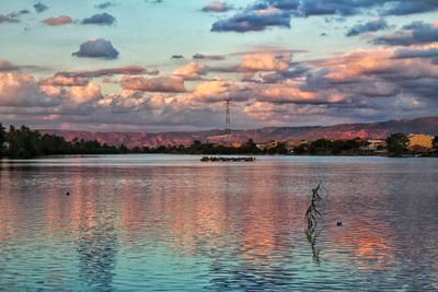 Scenic view of lake against sky at sunset