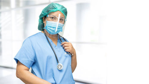 Portrait of doctor wearing mask standing outdoors