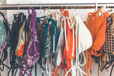 Multi colored clothes hanging on rack at store
