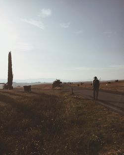 Man standing on field against sky