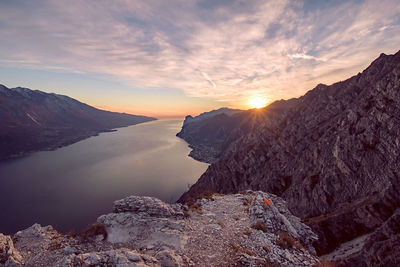 Scenic view of dramatic sky over lake during sunset