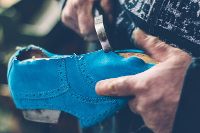Close-up of hands making shoe