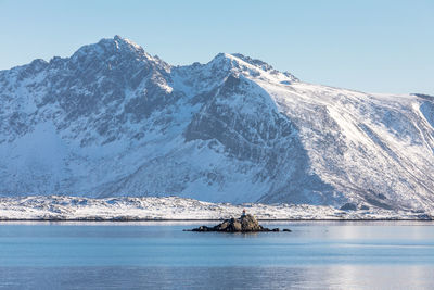 Scenic view of frozen lake against mountain range