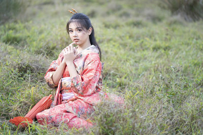 Woman sitting on field