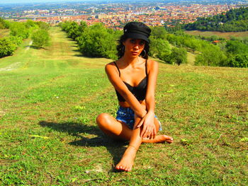 Young woman sitting on field