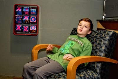 Boy sitting on chair