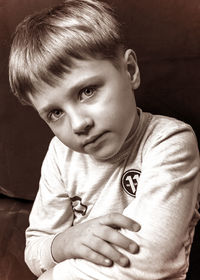 Portrait of boy sitting at home