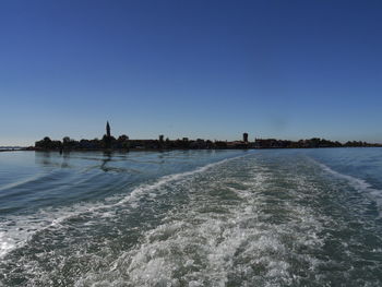 Scenic view of sea against clear blue sky