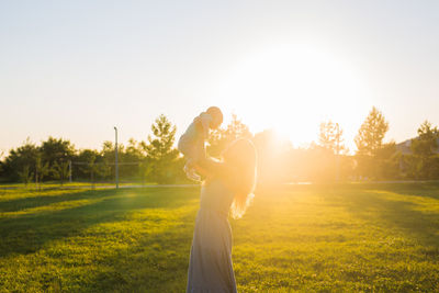 Side view of a woman standing on field