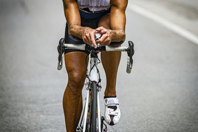 Midsection of man riding bicycle