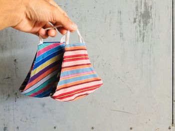 Close-up of hands holding multi colored wall