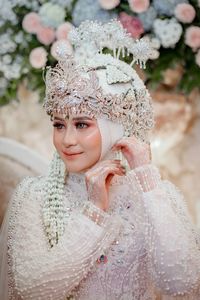 Portrait of smiling young woman wearing flowers