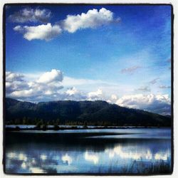 Scenic view of lake against cloudy sky