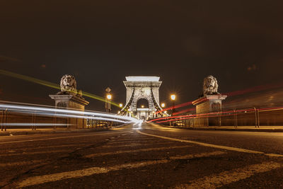 Light trails on szechenyi chain bridge in city at night