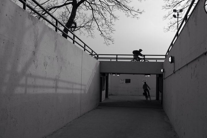 architecture, built structure, walking, the way forward, building exterior, men, full length, silhouette, lifestyles, rear view, street, building, day, wall - building feature, bicycle, wall, person