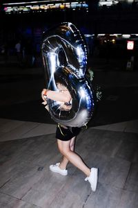 Midsection of woman dancing at night