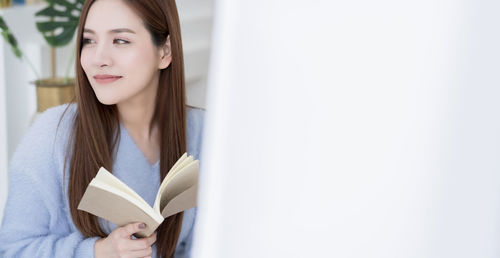 Young woman reading book