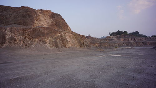 Scenic view of arid landscape against sky