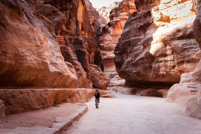 Rear view of man standing on rock