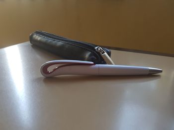 Close-up of pen and pouch on table