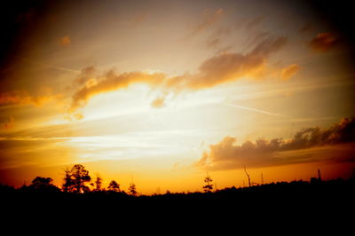 Silhouette of landscape against dramatic sky