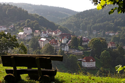 View of townscape by trees and houses on field