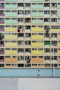 People in balcony of building in city