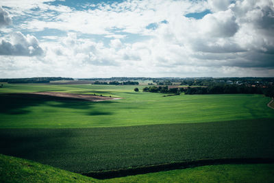 Scenic view of golf course against sky