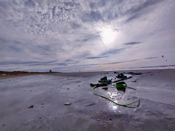 Scenic view of sea against sky during summer. a surfing board is resting after a long journey.