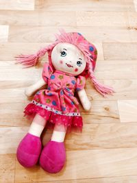 Close-up portrait of girl with hand on hardwood floor