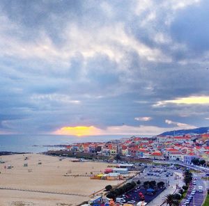 View of cityscape against cloudy sky