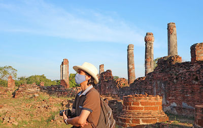 Visitor wearing face mask visit to wat phra si sanphet temple amid covid-19, ayutthaya, thailand