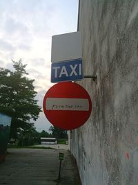 Low angle view of road sign against sky