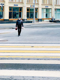 Full length of man walking on road