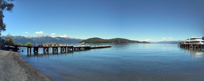 Pier over sea against blue sky