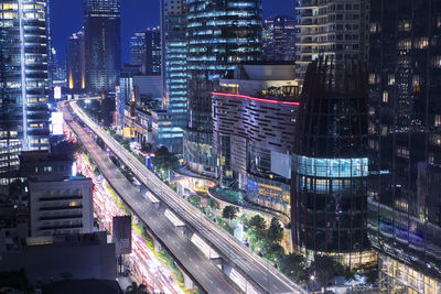 Illuminated city street and buildings at night