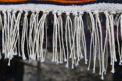 Close-up of icicles hanging on wood in winter