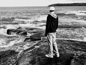 Rear view of man walking on beach