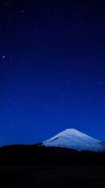 Scenic view of mt fuji against star field