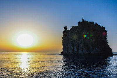 Scenic view of sea against clear sky during sunset