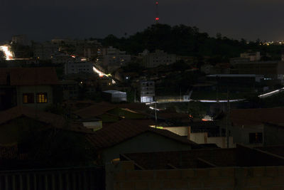 High angle view of illuminated town against sky at night