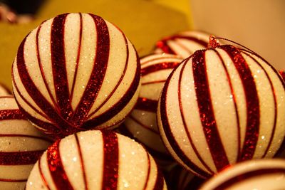 Close-up of white and red striped christmas baubles