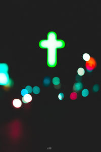 Close-up of illuminated lights against black background