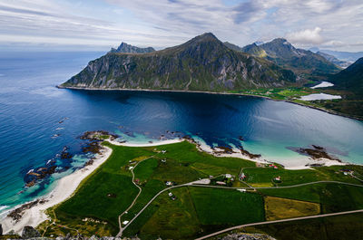 Scenic view of sea and mountains against sky
