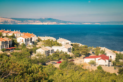 High angle view of townscape by sea