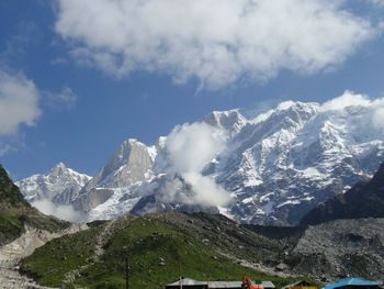 Scenic view of snow covered mountains against sky